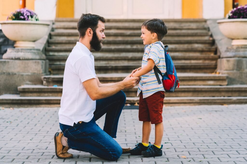 Dad encourages his son to go to school.