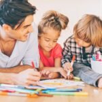 Kids develop their skills by coloring coloring pages with dad.